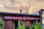 Czig Meister Brewing Company sign with rainbow in background
